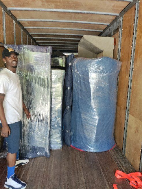 Furniture wrapped in plastic and moving blankets inside the Liberty Pro truck