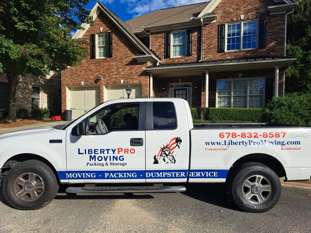 Professional movers wrapping furniture during Norcross GA relocation