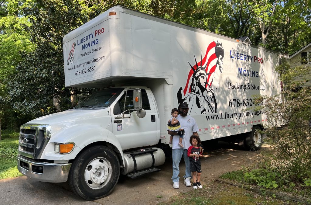 Professional movers wrapping furniture during Loganville Georgia move