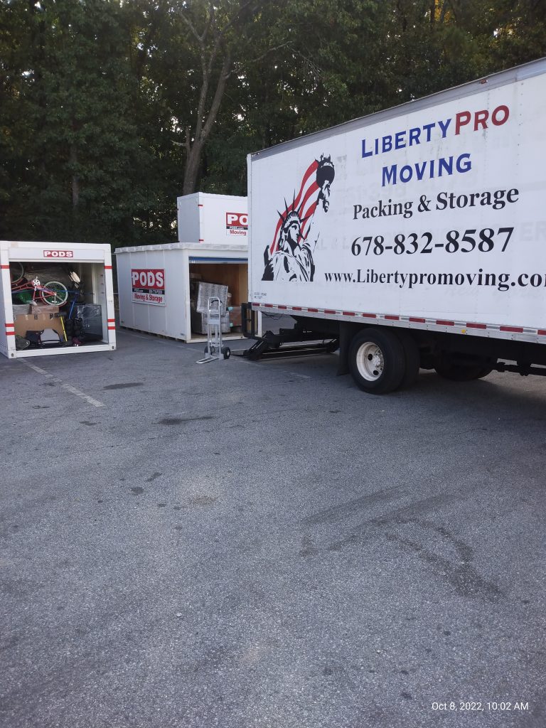 Professional movers wrapping furniture during Norcross GA relocation