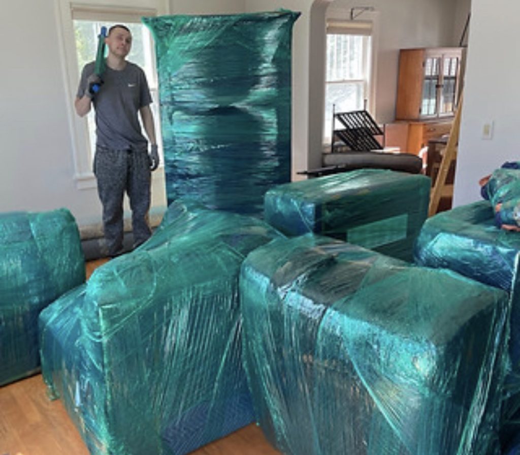 Professional movers wrapping furniture during Loganville Georgia move | Lawrenceville Moving Company | LIBERTY PRO MOVING Professional movers wrapping furniture during Loganville Georgia move
