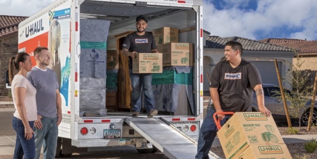 Packing household items carefully into boxes before relocation | Lawrenceville Moving Company | LIBERTY PRO MOVING Packing household items carefully into boxes before relocation