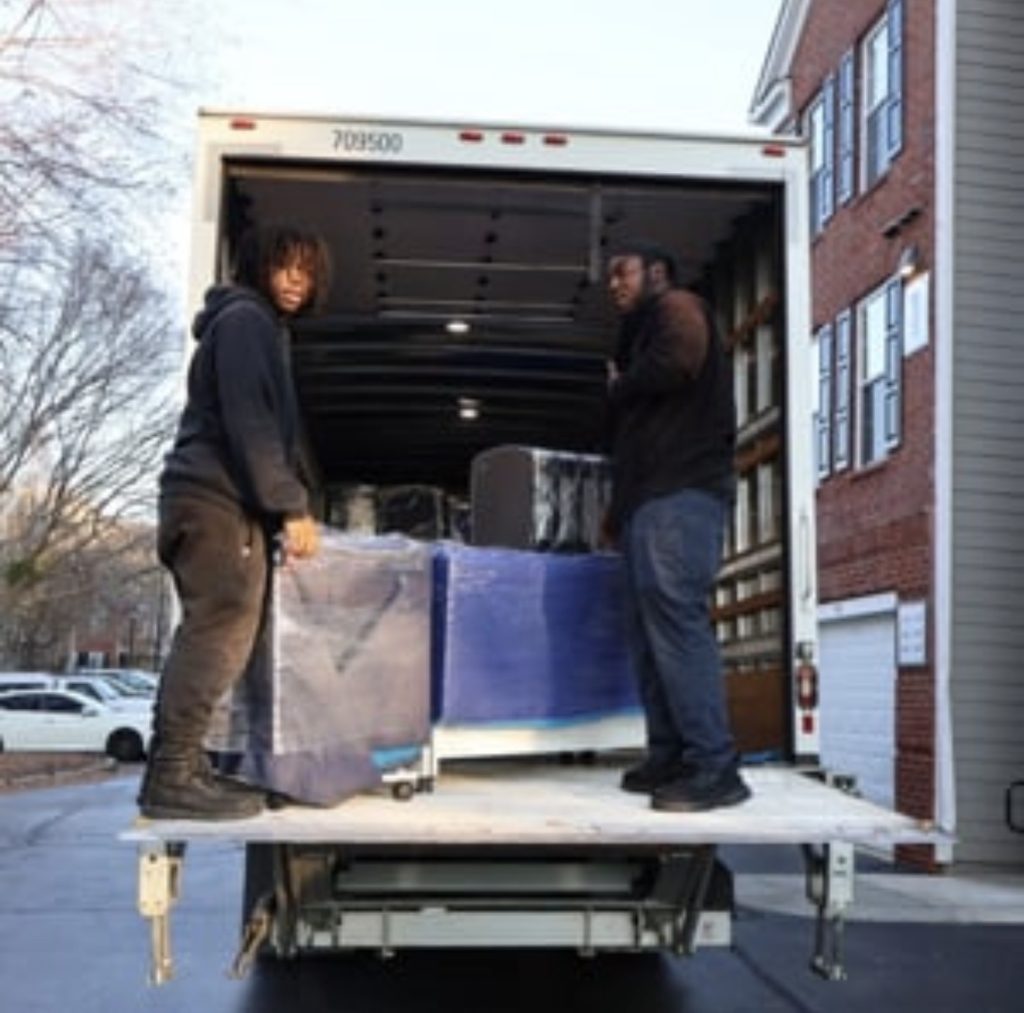 Professional movers loading boxes into a moving truck in Metro Atlanta | Lawrenceville Moving Company | LIBERTY PRO MOVING Professional movers loading boxes into a moving truck in Metro Atlanta