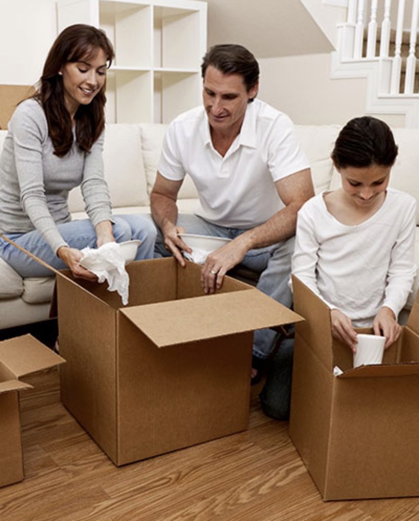 Moving crew protecting couch with stretch wrap before loading | Lawrenceville Moving Company | LIBERTY PRO MOVING Moving crew protecting couch with stretch wrap before loading