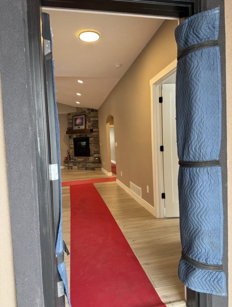 Movers navigating hallway apartment relocation | Lawrenceville Moving Company | LIBERTY PRO MOVING Movers navigating hallway apartment relocation