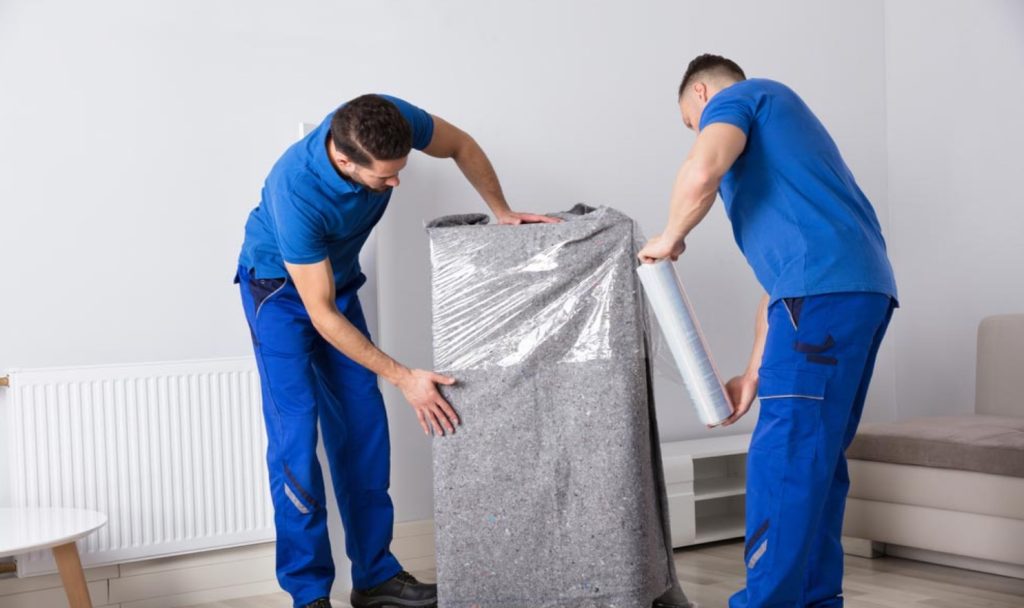 Professional movers wrapping furniture in Snellville GA | Lawrenceville Moving Company | LIBERTY PRO MOVING Professional movers wrapping furniture in Snellville GA